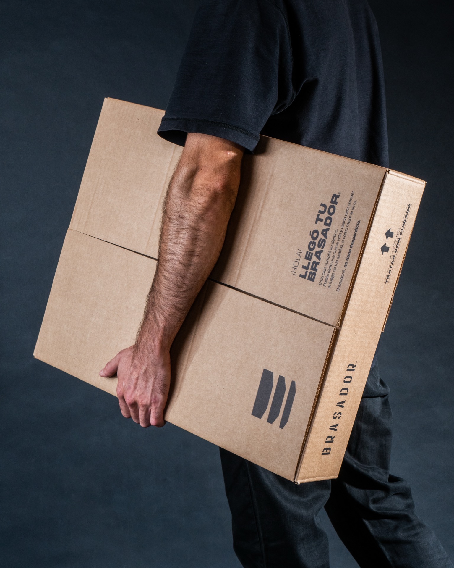 Brasador packaging — dark studio, isotype and editorial type